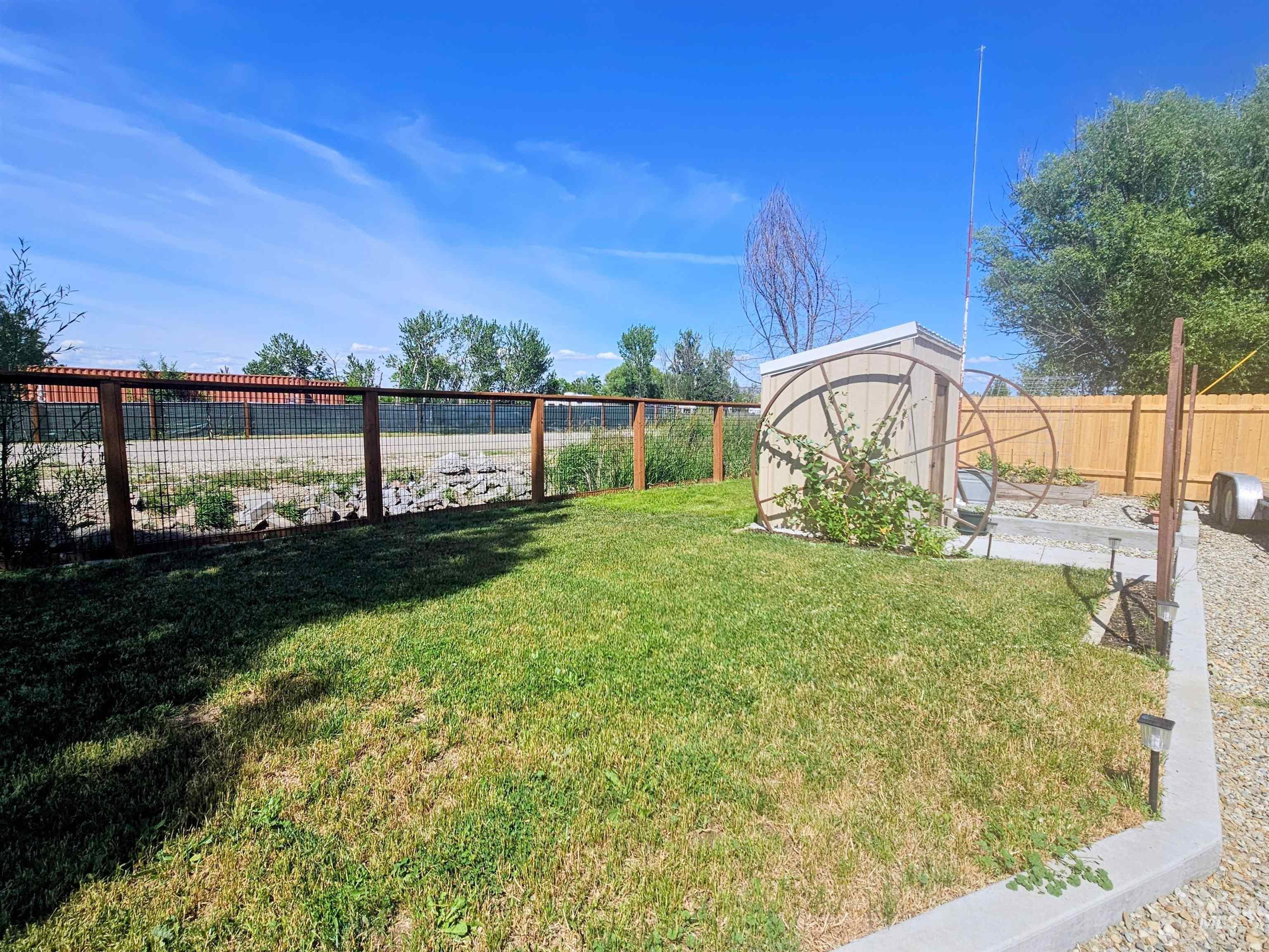 8392 Main Street Letha, ID 83636 - Photo 22 of 31 Expansive exterior featuring a manicured lawn, a gravel patio, and a utility shed