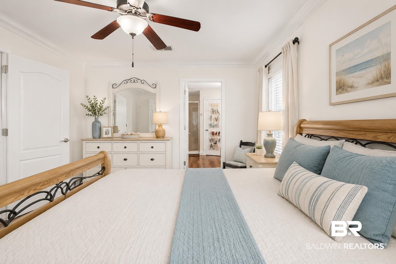 562 Vestige Mews Foley, AL 36535 - Photo 23 of 54 AI Edited Image: Spacious room featuring a ceiling fan with integrated lighting, crown molding, white paneled doors, and wood-finish flooring visible in the background