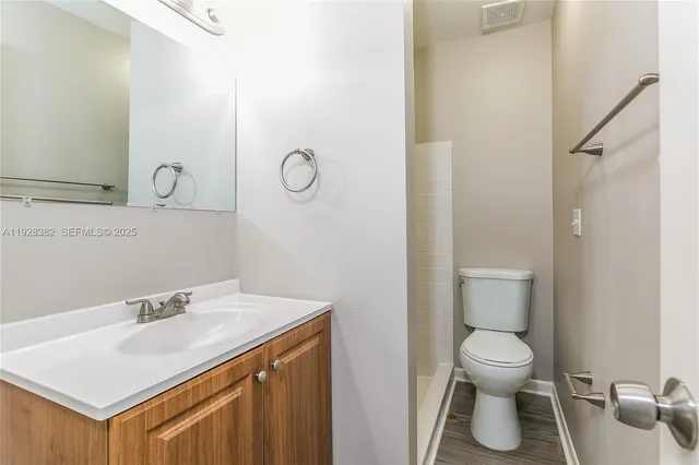 a bathroom with a sink toilet and a mirror