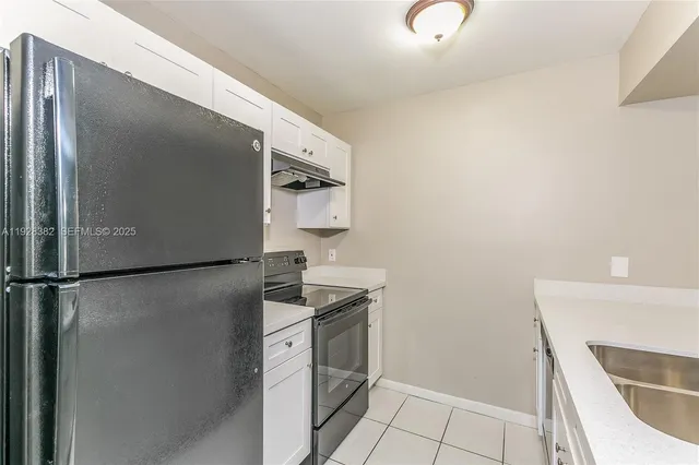 a kitchen with a refrigerator and a stove