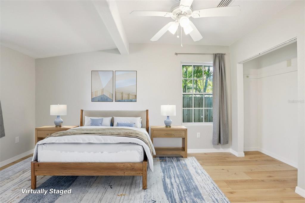 13135 4th Street East Madeira Beach, FL 33708 - Photo 14 of 24 a bedroom with a large bed and a chandelier