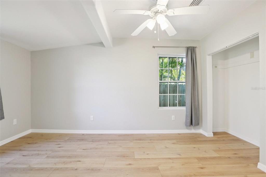 13135 4th Street East Madeira Beach, FL 33708 - Photo 15 of 24 a view of an empty room with wooden floor and a window
