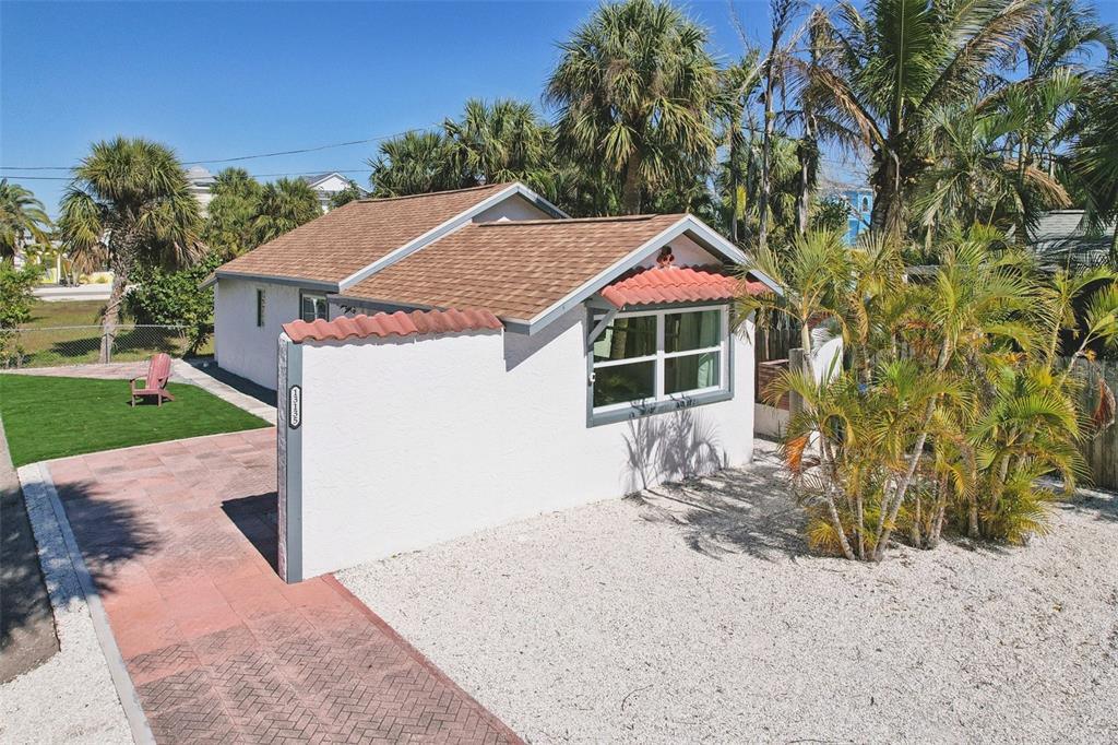13135 4th Street East Madeira Beach, FL 33708 - Photo 17 of 24 a house with trees in the background