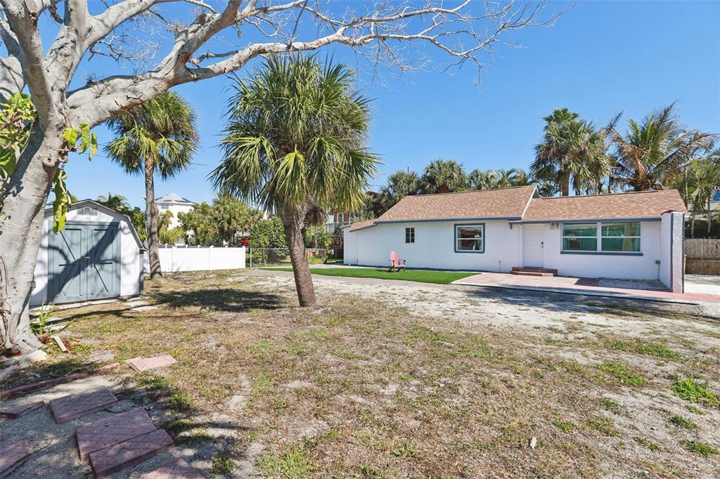 13135 4th Street East Madeira Beach, FL 33708 - Photo 20 of 24 a view of a yard with a house and a tree