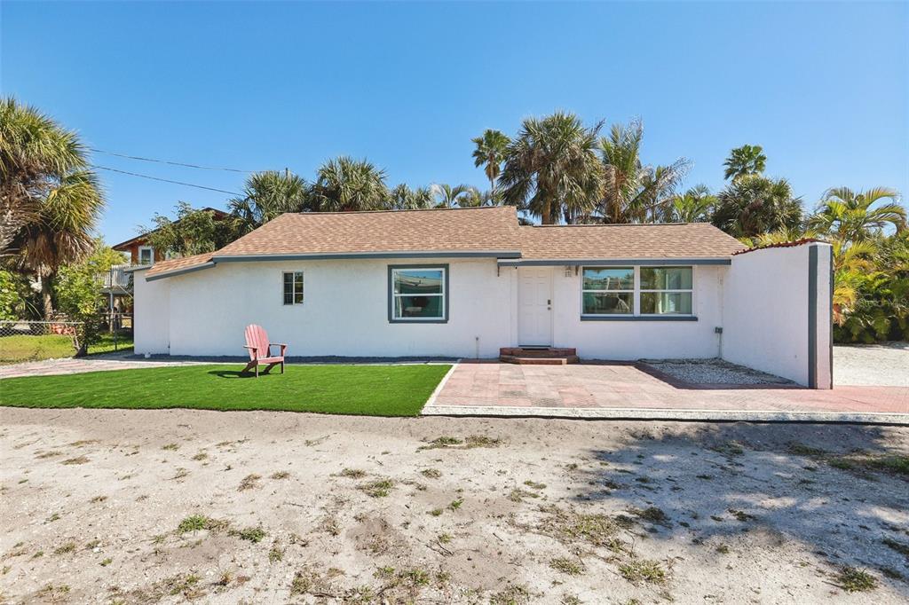 13135 4th Street East Madeira Beach, FL 33708 - Photo 24 of 24 a front view of a house with a garden and yard