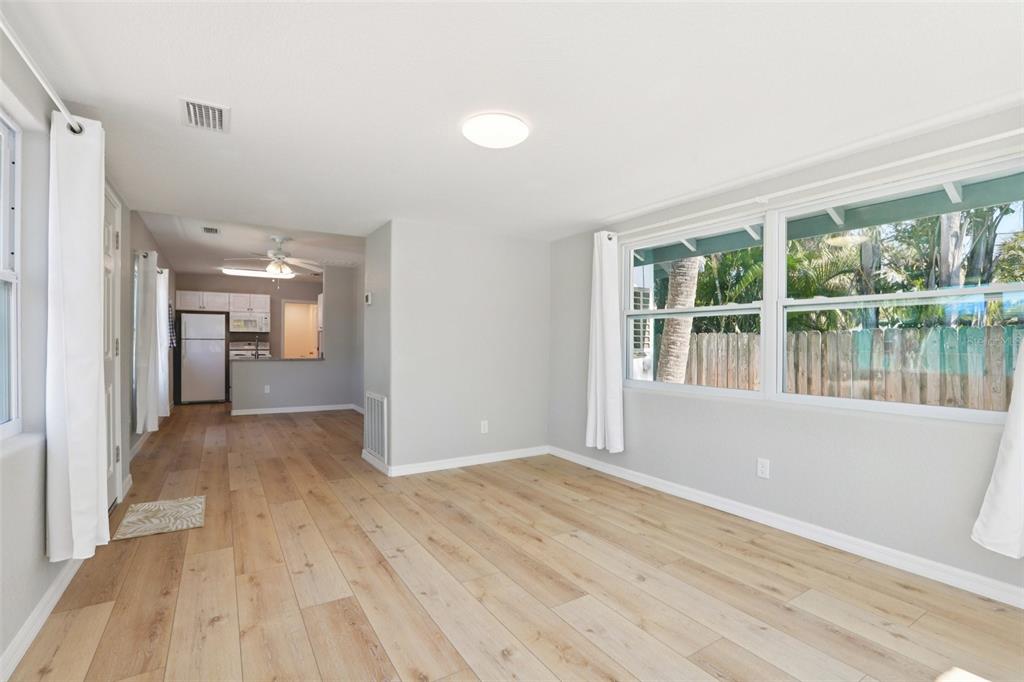 13135 4th Street East Madeira Beach, FL 33708 - Photo 6 of 24 wooden floor in an empty room with a window