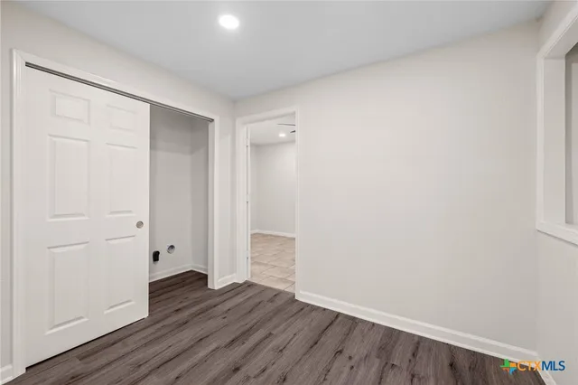 an empty room with wooden floor