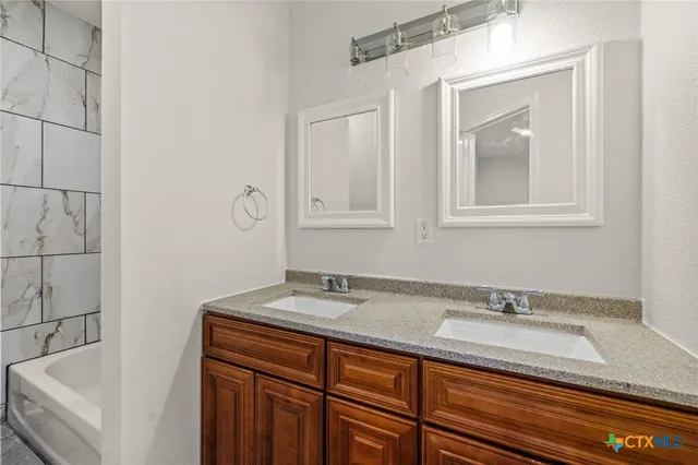 a bathroom with a sink and a mirror