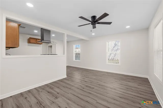 a view of a livingroom with a hardwood floor and a ceiling fan