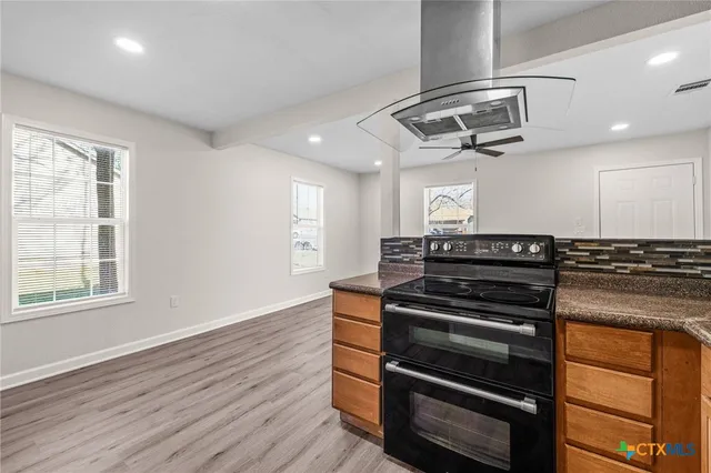 a kitchen with a stove and a microwave