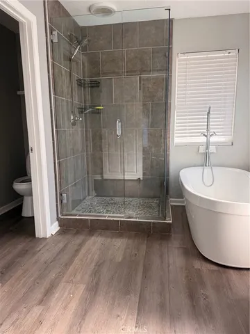 a bathroom with a bathtub and a shower