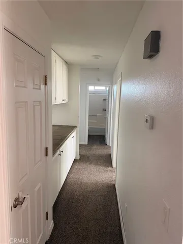a large white bathroom with sink and mirror