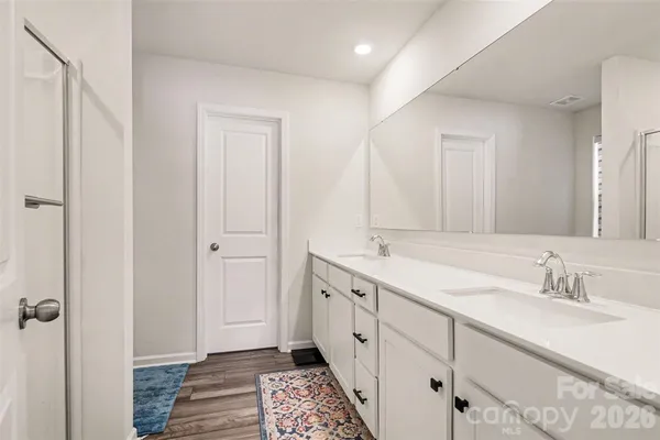 a spacious bathroom with a double vanity sink and a mirror