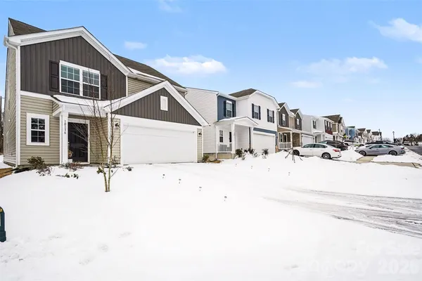 a view of a house with a snow on the road