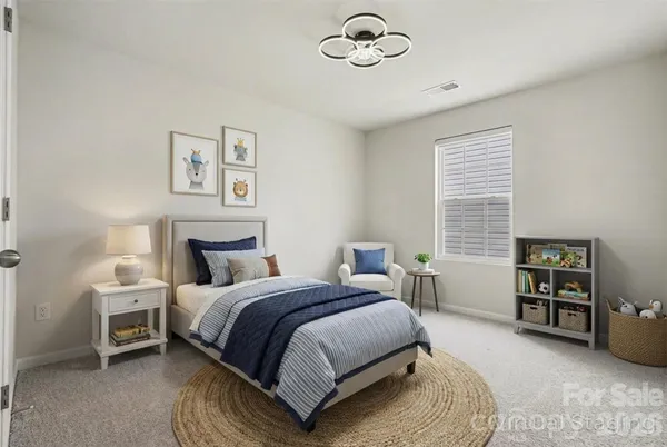 a spacious bedroom with a bed and a table