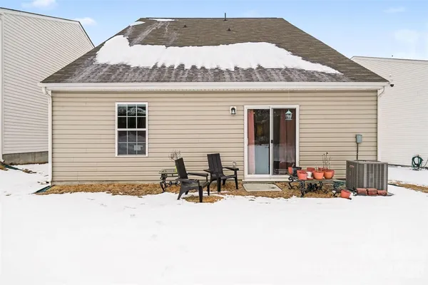 a group of people sitting in front of a house