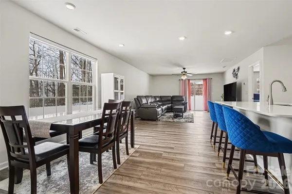 a view of a dining room with furniture window and wooden floor