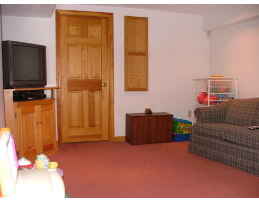 10 Cozy Street, Unit 10 Watertown, MA 02472 - Photo 9 of 11 a living room with a couch and a flat screen tv