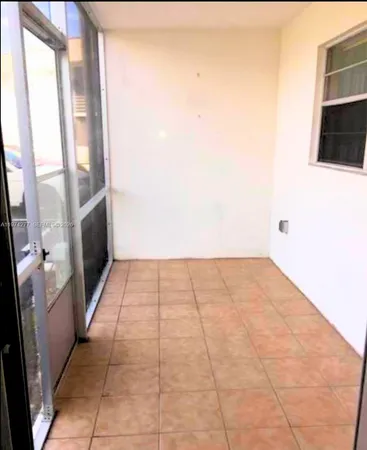 a view of an empty room with a fireplace