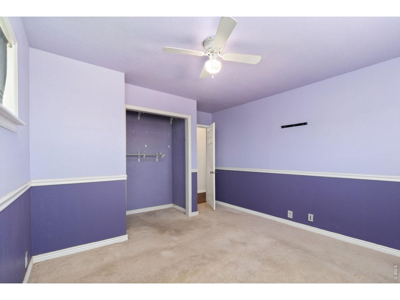 245 6th Street Frederick, CO 80530 - Photo 12 of 17 a view of an empty room with a chandelier fan