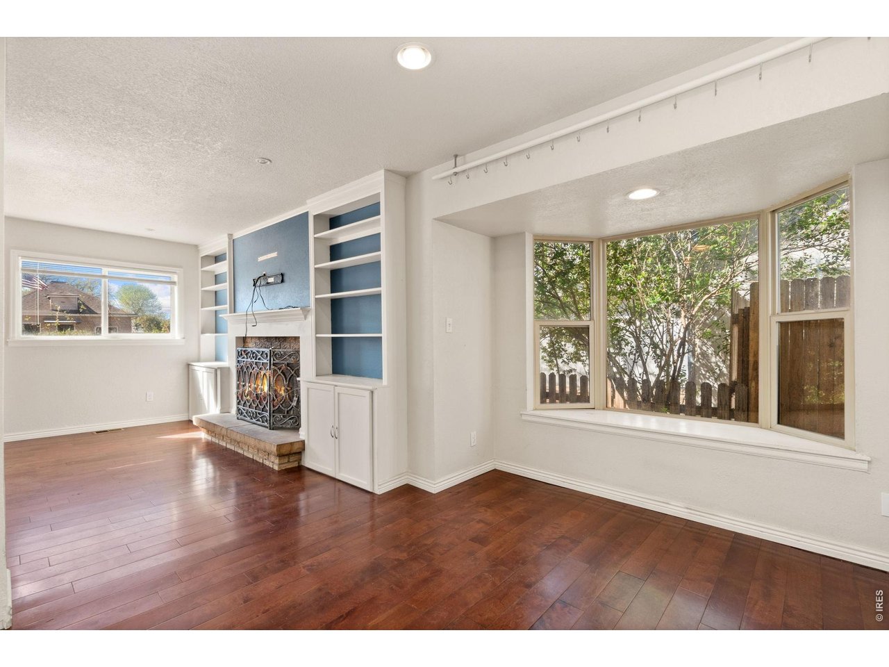245 6th Street Frederick, CO 80530 - Photo 5 of 17 a view of an empty room with a window and wooden floor