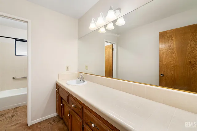 a bathroom with a sink a vanity and a mirror