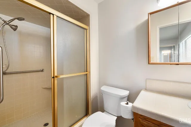 a white toilet sitting next to a bathroom sink