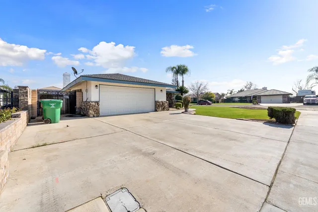 a view of a house with a yard and sitting area