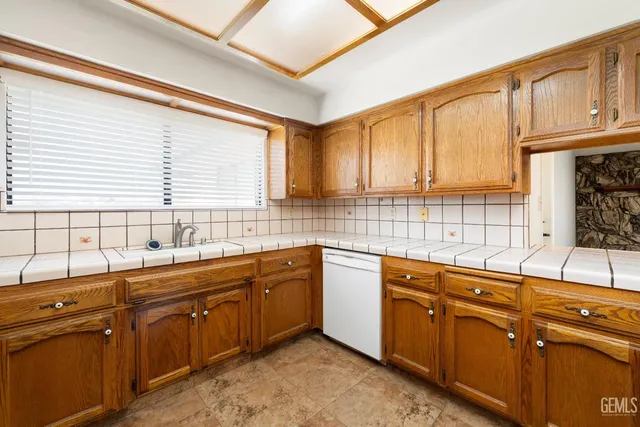 a kitchen with stainless steel appliances granite countertop a sink and cabinets