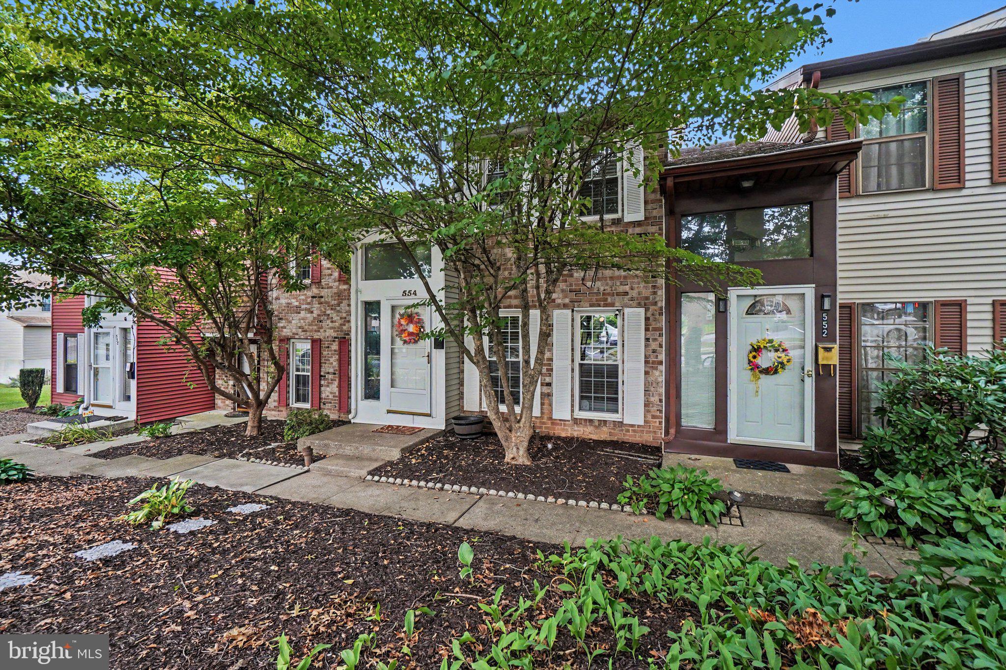 Charming townhome with lush greenery.