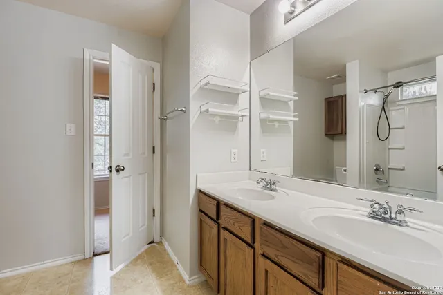a bathroom with a double vanity sink mirror and double