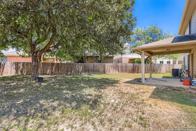 a view of a backyard with a small cabin and a chair