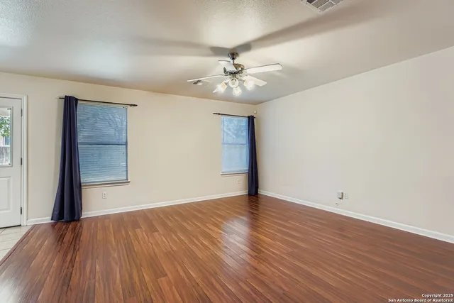 wooden floor in an empty room with a window