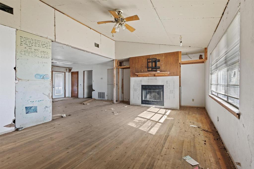 3467 East Fm 120 Denison, TX 75021 - Photo 13 of 38 a view of an empty room with a fireplace and a window