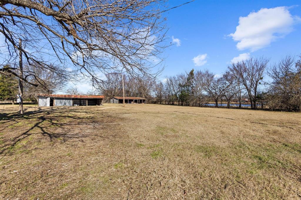 3467 East Fm 120 Denison, TX 75021 - Photo 6 of 38 a view of a yard with trees and a wooden fence