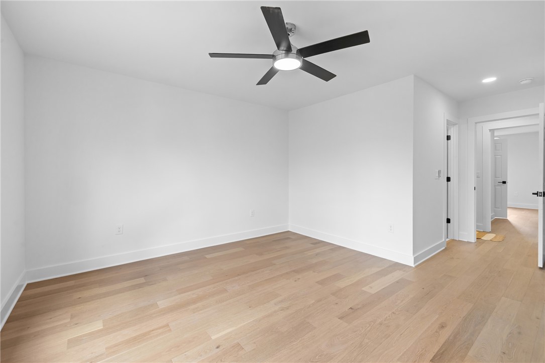 117 Riverpoint Drive Clemson, SC 29631 - Photo 28 of 47 This airy room features light wood flooring and a modern ceiling fan, creating a refreshing atmosphere.