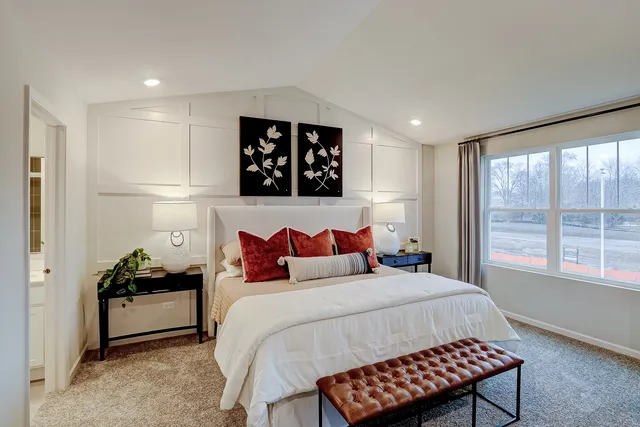 a bedroom with bed and a large window