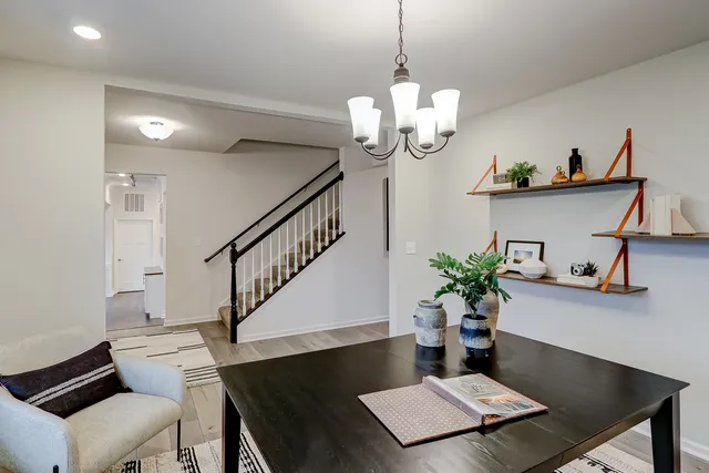 a view of a dining room with furniture wooden floor and a chandelier