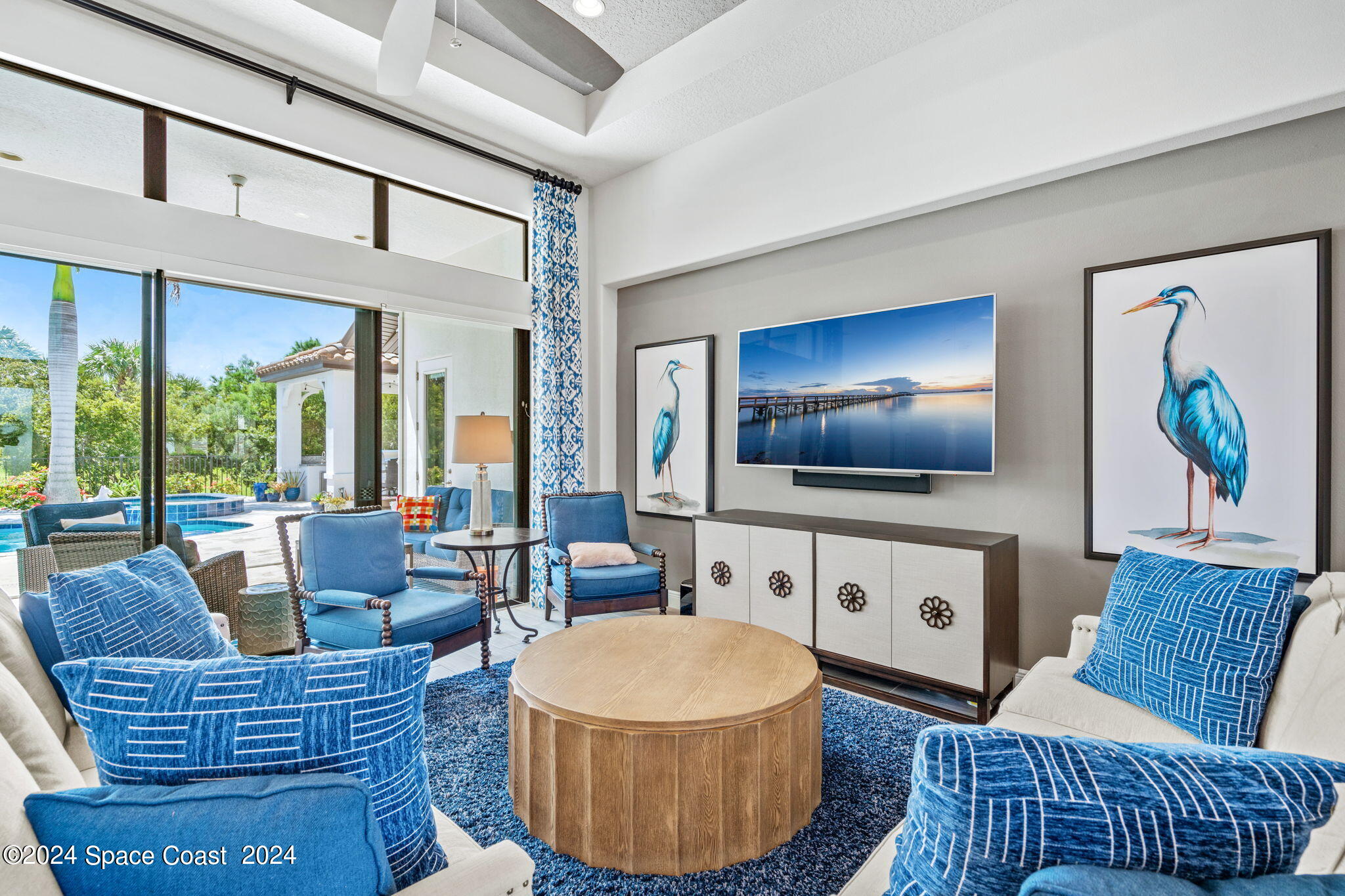 5187 Kirkwall Circle Melbourne, FL 32940 - Photo 9 of 53 a living room with furniture a flat screen tv and a large window
