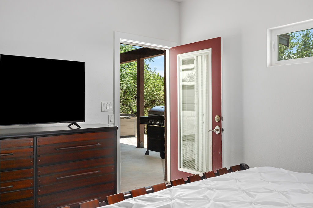 13326 Trautwein Road Austin, TX 78737 - Photo 18 of 38 Bedroom featuring access to exterior