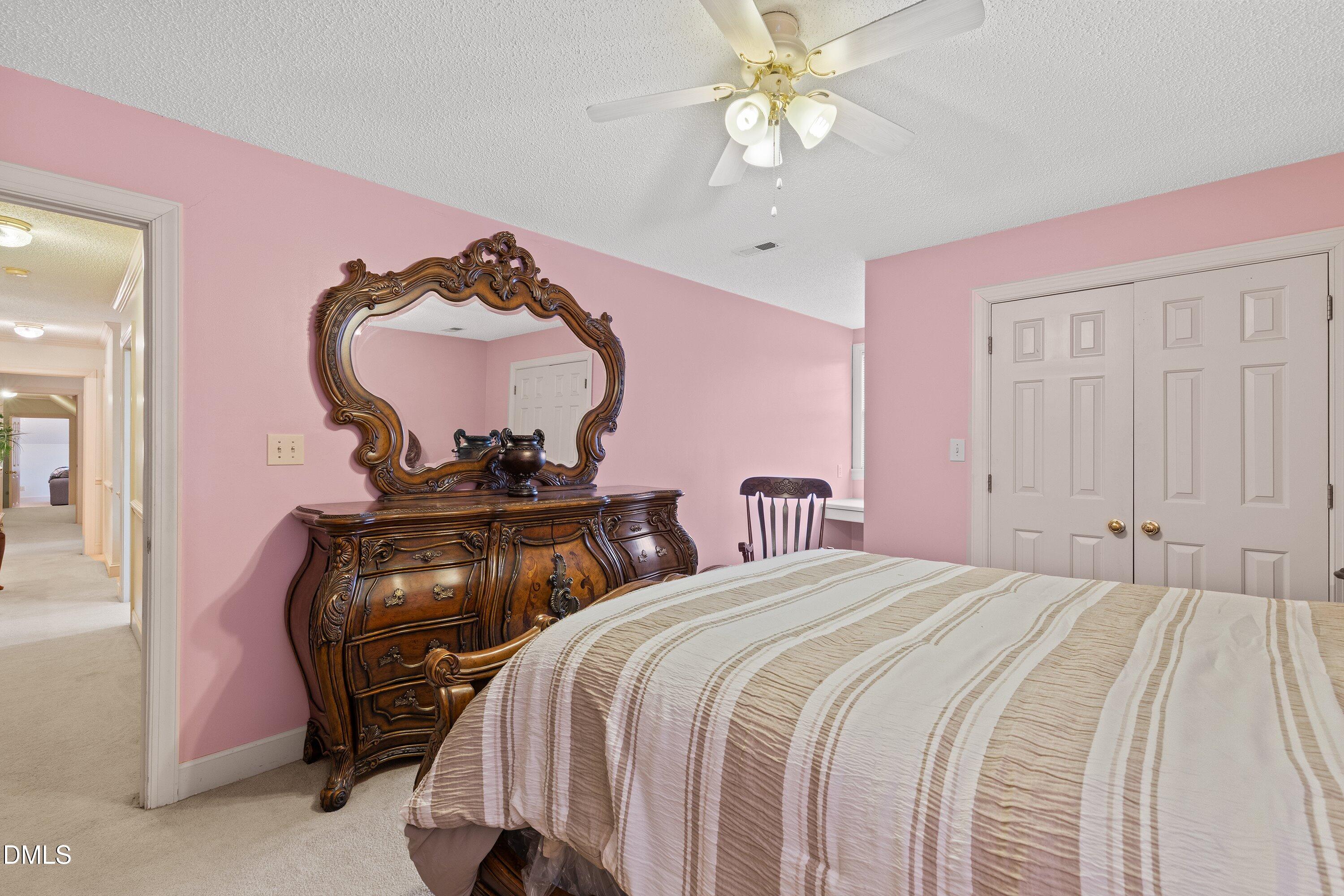6314 Old Davis Road Sims, NC 27880 - Photo 40 of 71 a bedroom with a bed and a chandelier