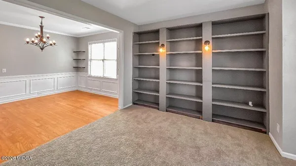 a view of a room with wooden floor