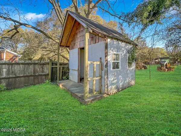 a view of a back yard of the house with green space