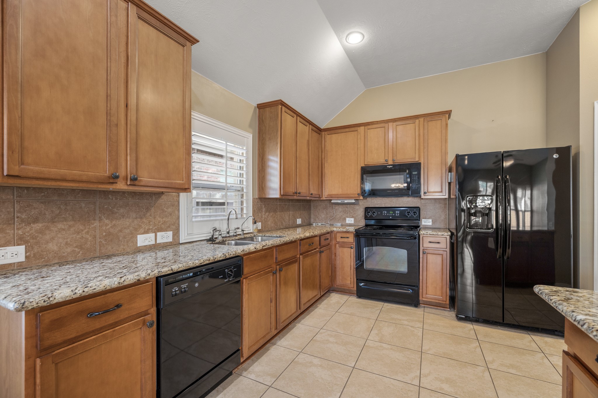 20014 Queens Oak Court Spring, TX 77379 - Photo 14 of 49 a kitchen with stainless steel appliances granite countertop a refrigerator and a stove top oven