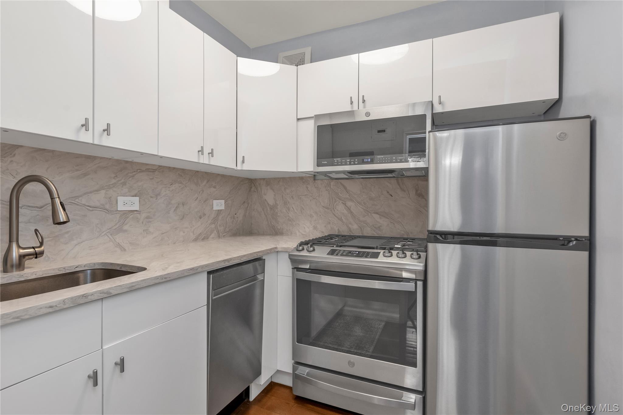 110-45 71st Road, Unit 3N Queens, NY 11375 - Photo 6 of 12 Renovated Kitchen w/ new stainless-steel appliances, quartz countertops