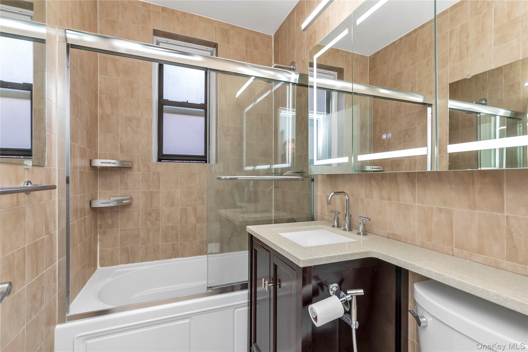 110-45 71st Road, Unit 3N Queens, NY 11375 - Photo 8 of 12 Bathroom with sleek new medicine cabinet & new toilet