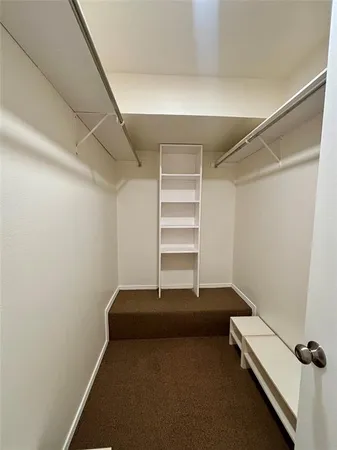 a view of room with stairs and wooden floor