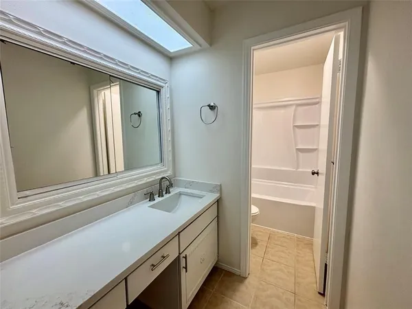 a bathroom with a sink a vanity and a mirror