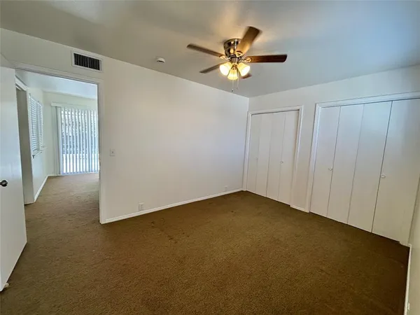 a view of a livingroom with a chandelier fan