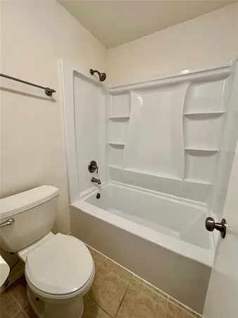 a bathroom with a toilet and a bathtub